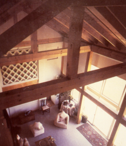 The two-story timber frame living room of a home. 