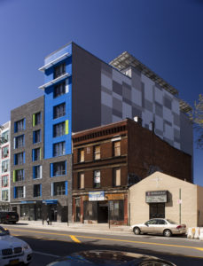 A multifamily building with a gray and blue exterior at 3365 Third Avenue in the Bronx.