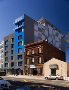 A multifamily building with a gray and blue exterior at 3365 Third Avenue in the Bronx.