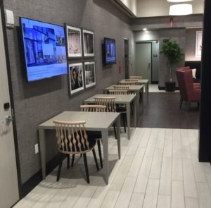 Hotel dining area with tables and seating arranged throughout a guest amenity space.