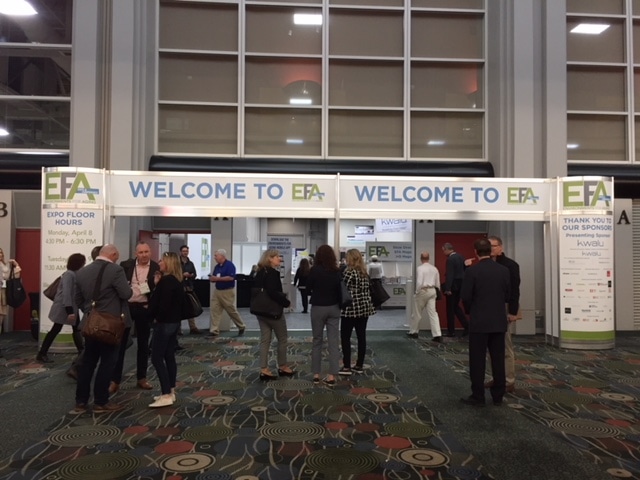 entry way of conference with attendees walking in