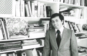 Steven Winter standing in front of the bookshelf in his office.