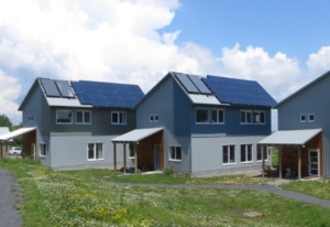 A rendering of sustainable homes with roof solar panels at TREE at EcoVillage. 