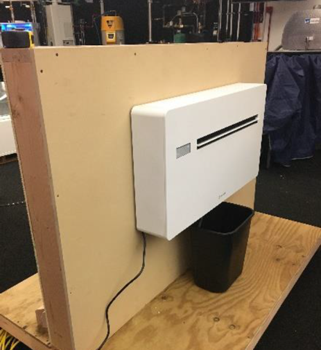 Packaged terminal heat pump mounted in a laboratory wall mock-up for airtightness testing and product evaluation.