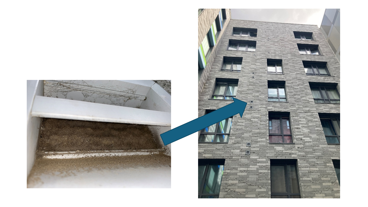 Exterior intake grill for an in-unit energy recovery ventilator blocked by dust and debris, reducing fresh air intake.