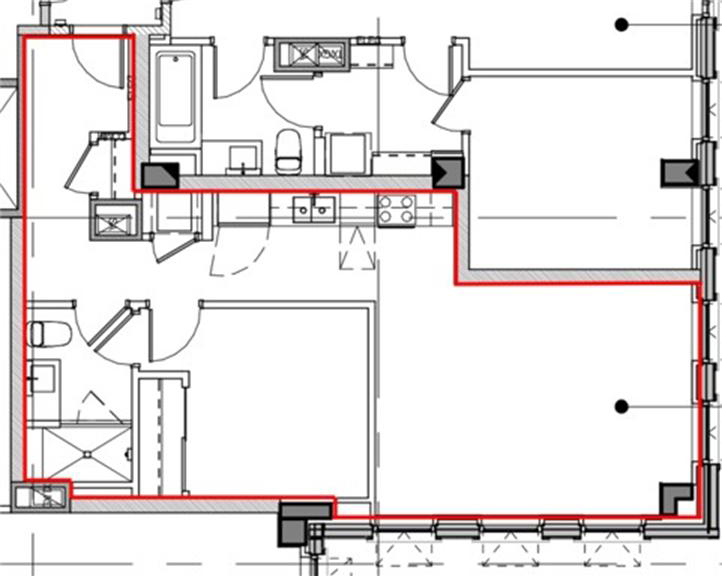 Plan view of a multifamily residential unit with the compartmentalization air‑barrier path outlined in red. The highlighted barrier follows the perimeter drywall around exterior walls, corridor walls, and party walls separating the unit from adjacent dwelling units.