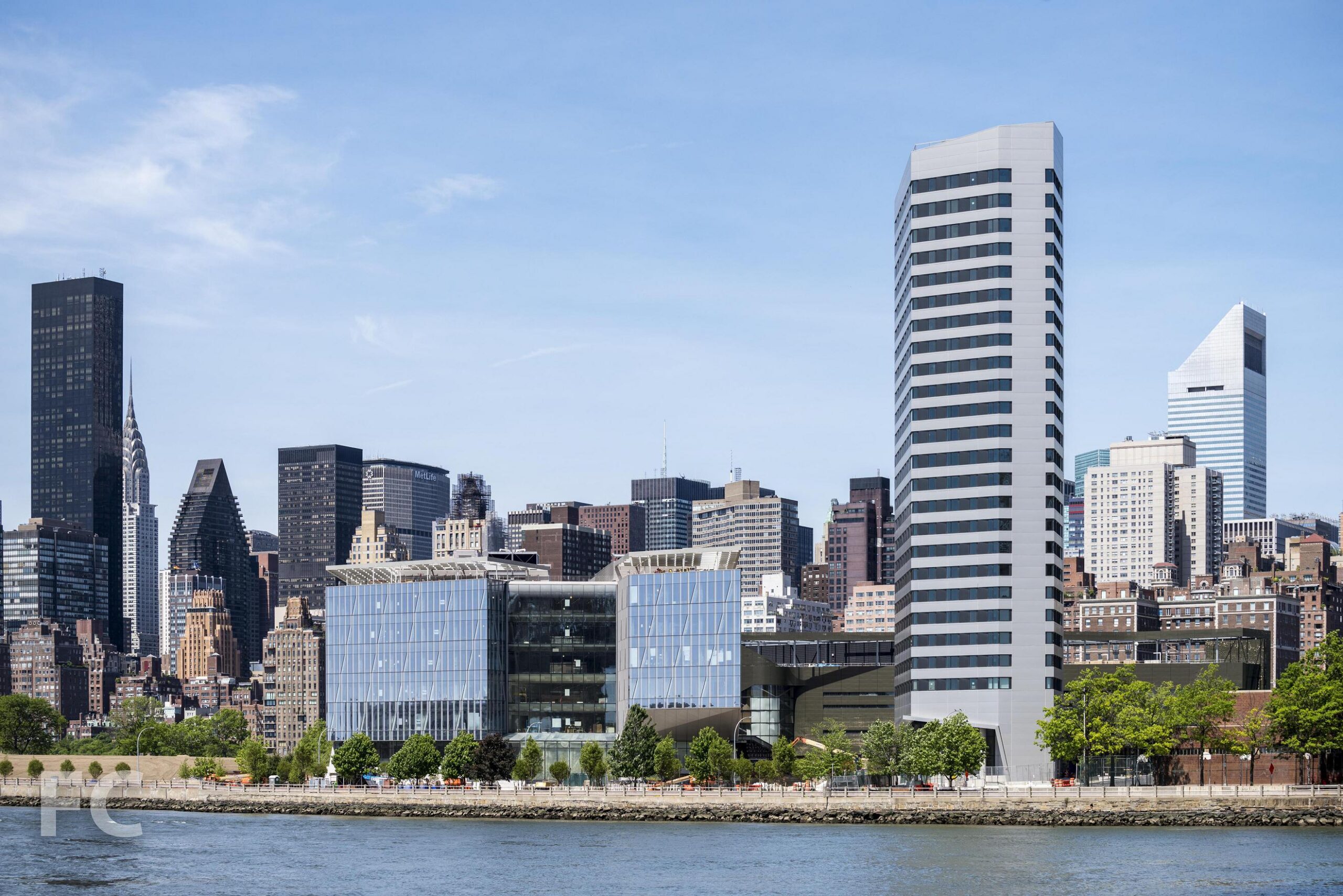 The House at Cornell Tech, a high-rise Passive House residential tower on Roosevelt Island, with the Manhattan skyline in the background.