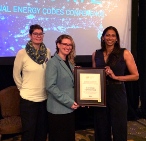 Photo of Patricia Chawla, Alison Lindburg, and Gayathri Vijayakumar holding the 2023 ICC National Leadership in Sustainability and Energy Efficiency Award.