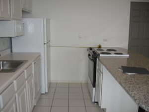 Projecting appliances often encroach into the required clearance in dwelling unit kitchens.