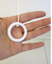 A ring attached to the string of a bathroom nurse call device.