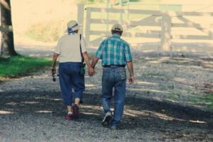 image of senior couple holding hands and walking