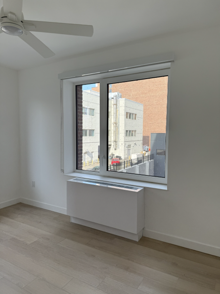 Packaged terminal heat pump installed beneath a window in an apartment in a new Passive House.