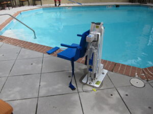 A pool lift mechanical chair that can lower a person into a pool.
