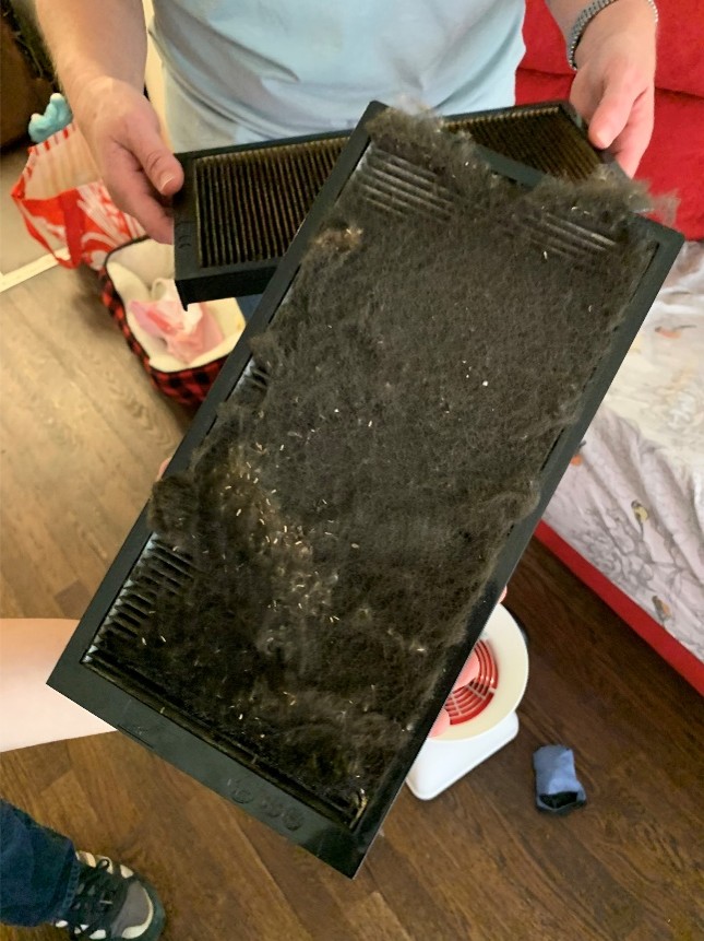Ventilation system filter covered with accumulated dust and debris after extended operation without maintenance.
