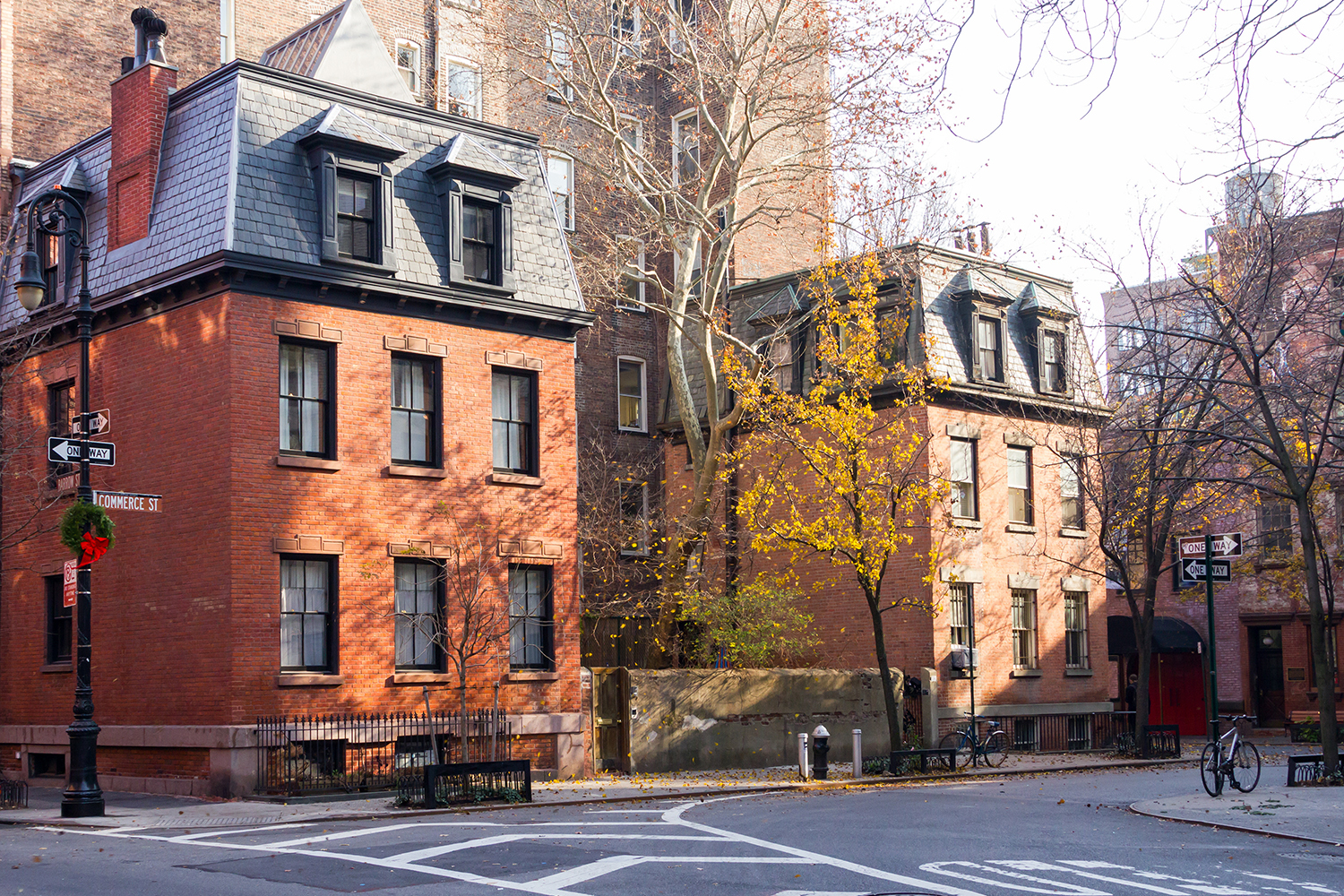 Exterior view of the Twin Sisters townhouses at 39 and 41 Commerce Street, showing restored brick façades and mansard roofs in Greenwich Village.